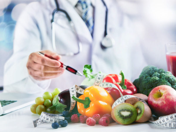 Modern doctor or pharmacy agent contact for healthy food and diet. A scene for Health concepts diet lost the plans with fresh vegetables and fruits